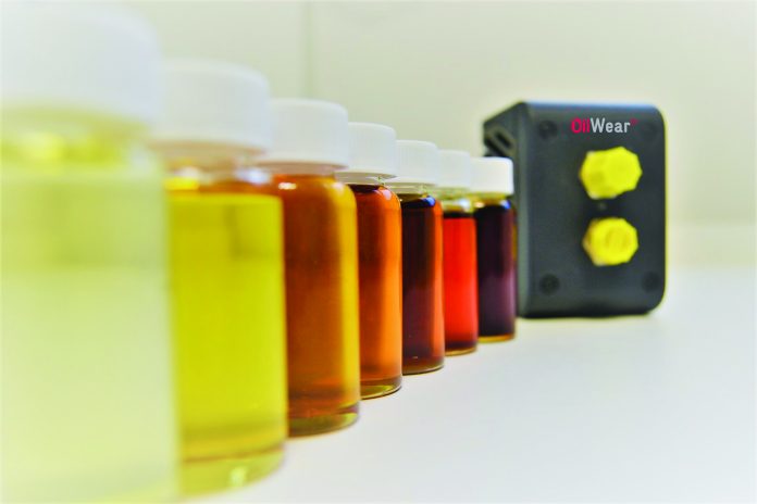 Oil samples lined up in order of colour, plus an Atten2 oil sensor